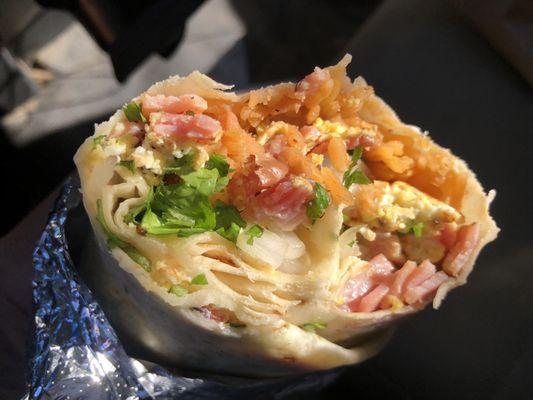 Breakfast burrito with refried beans, ham, rice and eggs. Excellent!!!