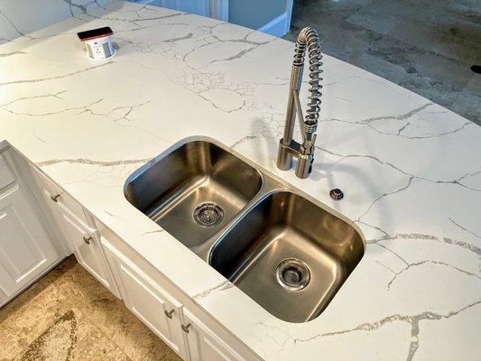 Pop up electrical and phone charger unit.  Stainless Steel Sink, Faucet and Garbage Disposal Button.