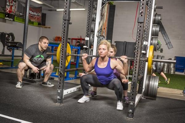 Coaching clients to squat properly.