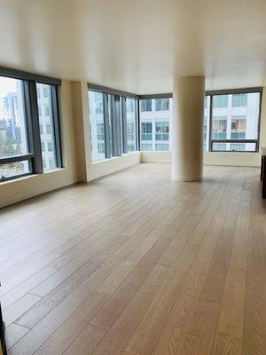 The image presents a penthouse in Bellevue featuring light hardwood flooring.