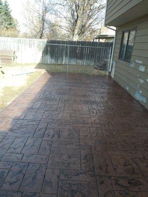 Stamped concrete patio, fence and retaining wall