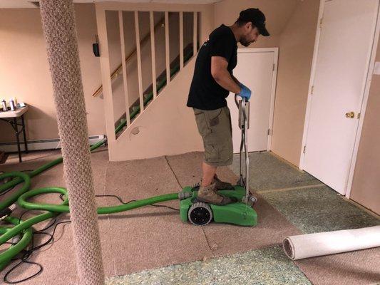 crew working hard to make sure homeowners basement is cleaned and dryed from water damage