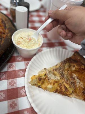 Coleslaw and a slice of the bbq bacon chicken cheddar pizza