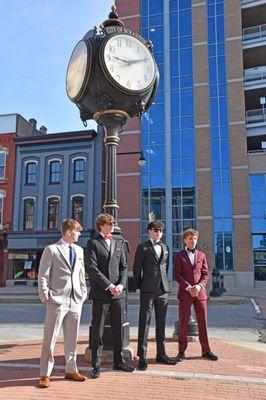 A group of young people wearing prom formalwear