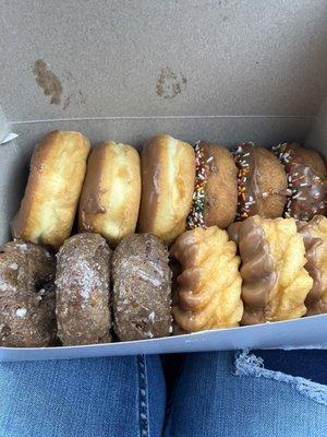 A dozen doughnuts! 3 chocolates glazed, 3 chocolate, 3 chocolate frosting with sprinkles, and 3 crinkle chocolate frosting doughnuts!