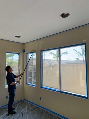 This is our coworker painting the wall.