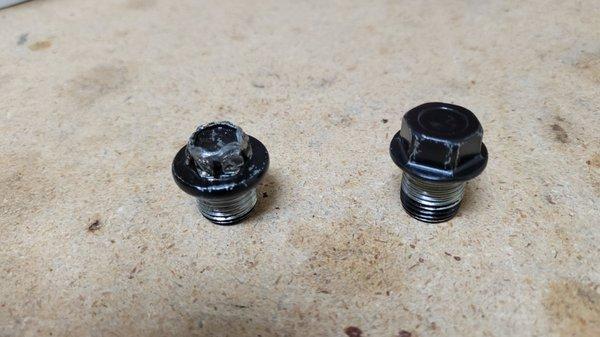 Left: Mangled "factory" 14-mm plug from our 2017 Forester; Right: After-market 17-mm plug installed by Wagon Works on our 2015 Forester.