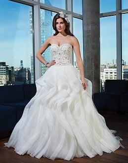 9750: Shown in Ivory/Silver. Heavily hand beaded organza drop waist bodice featuring a sweetheart neckline.