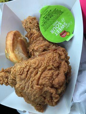 Two piece fried chicken with a biscuit and sauce for $3.19.