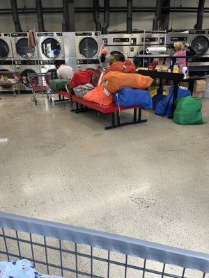 Benches covered in laundry bags.