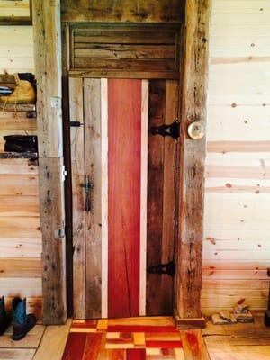 custom woodwork done with reclaimed barn wood and custom door.  Handles were fashioned from a pair of antique ice skates :)