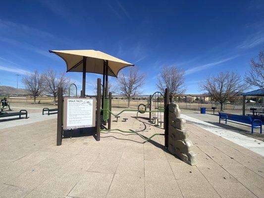 Small playground surrounded by benches