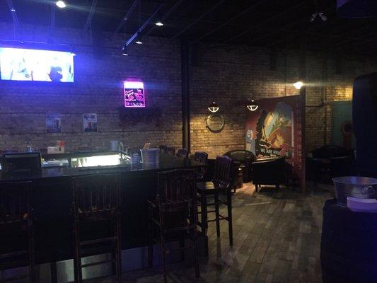 Redone pub with Tv's, dart boards, a video game system, and all you can eat peanuts