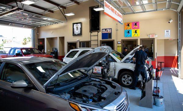 Team members working on cars