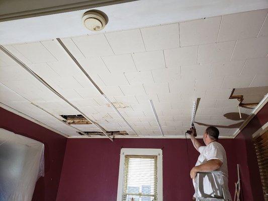 Damaged ceiling being removed.