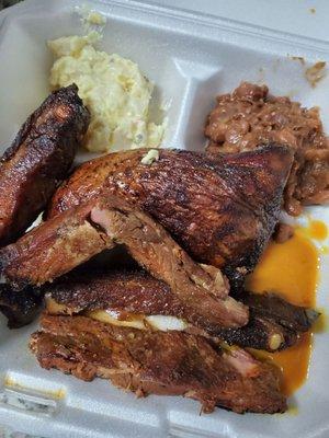 Ribs chicken and really dry baked beans and potato salad