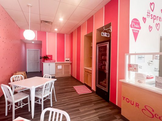 The bright and cheery inside of our South Fayette scoop shop. In this picture, you can see some of our seating area and our pint freezer.