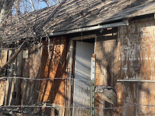 Abandoned house- other side of the fence.