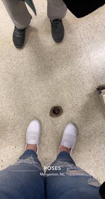 a hole in roses floor near the bedding and shoe area