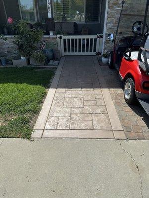 Beautiful stamp concrete, rock walls, stunning cap on wall and completely redid golf cart pad. James, MJ rock!