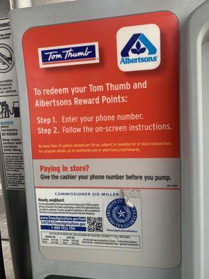 Sign on pump saying to enter reward number/ask cashier before swiping.