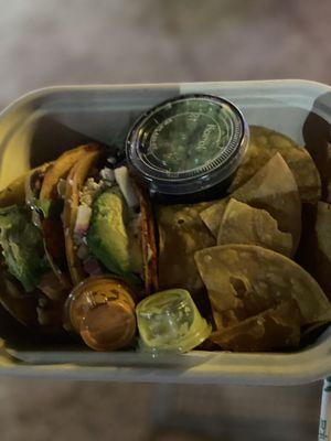 Beef and fish taco with chips and guacamole