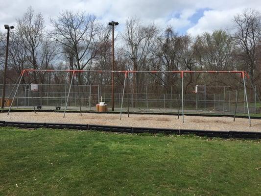 Swings, basketball courts behind