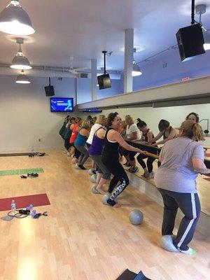 Barre class, using exercise balls, bands, and weights.