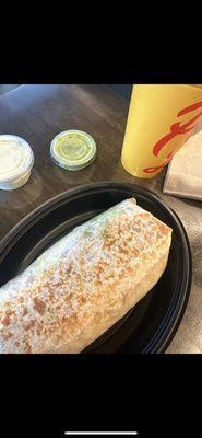 Queso guacamole burrito great an cheesy I love it with the creamy cilantro and avocado salsa