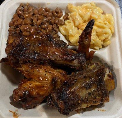 BBQ chicken and BBQ beef ribs with Mac n' cheese and baked beans.