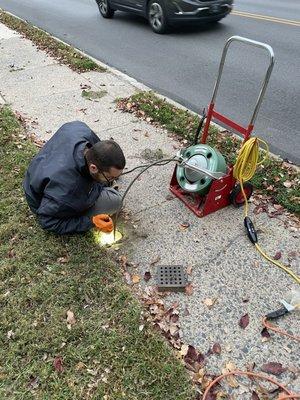 Derek exploring and clearing the sewer of roots.