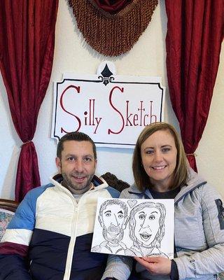 A couple merry customers with their finished Classic Black & White Caricatures.