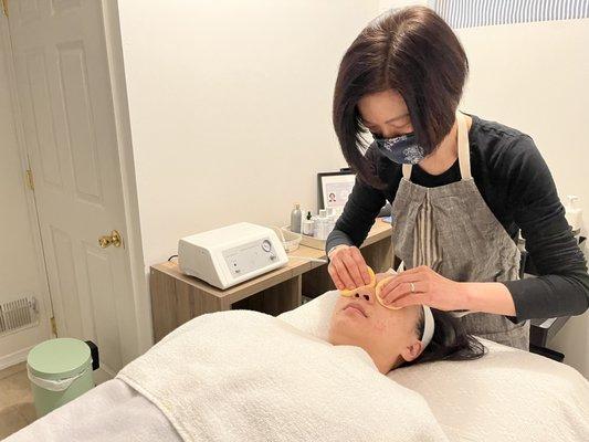 Sue C starting off with double cleansing as part of the Deep Pore-Cleansing Acne Facial.