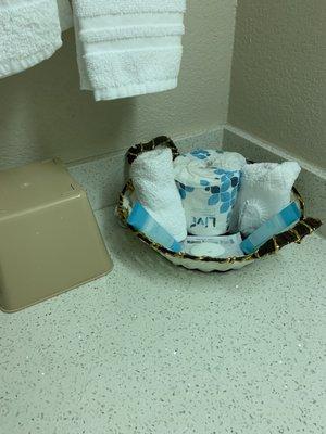 Scimpy basket with only 1 small bar of soap and 2 tiny tubes of shampoo.