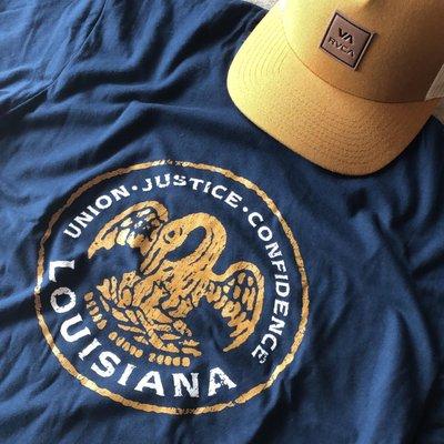 This vintage Louisiana state seal T pairs well the RVCA All the Way Trucker!