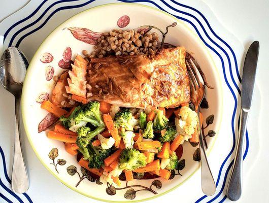 Baked salmon with a low-sodium soy and stem ginger dressing served with farro and a medley of vegetables.