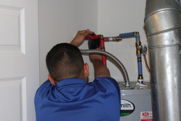 Tech fixing a water heater