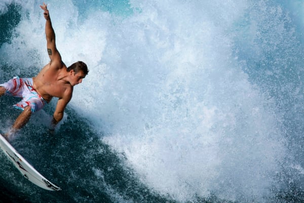 Surfing at Sunset Beach in Oahu, shot from a helicopter