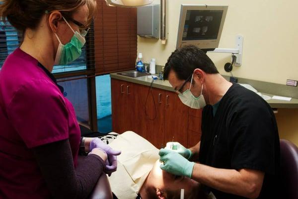 Dr. Lavrisa providing free dental treatment in the Dentist With A Heart Program.