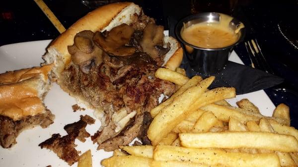 Philly Cheesesteak - shaved Ribeye, provolone, mushrooms, fries, side of cheese sauce.  Also comes w/ peppers & onions.