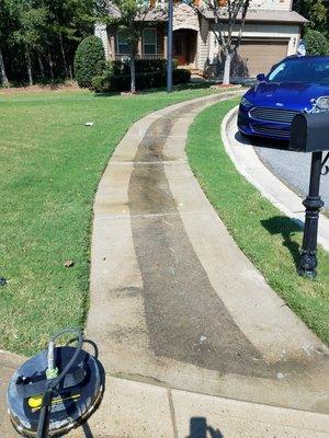 All Clear Cleaning Inc pressure washing a sidewalk. Look at the difference.