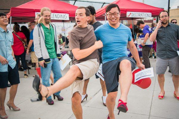 Vidmob employees vamp at the Walk a Mile in her shoes fundraising event for the Elizabeth Freeman Center at Third Thursday in Pittsfield, MA