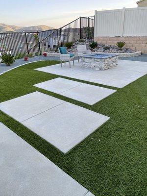 Fire pit (before furniture), more turf and corner planter with underground watering.