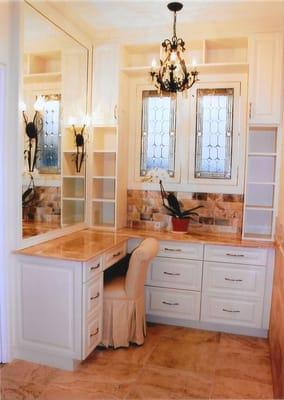 Behind the leaded glass doors is a ground level window to this remodeled bathroom.