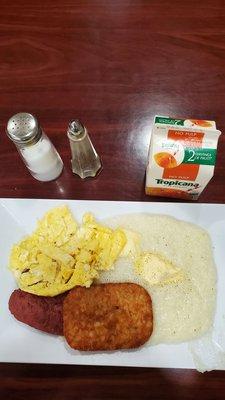 Grits and eggs. Hash brown. Beef sausage. OJ.