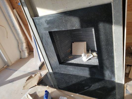 Clean lines and crisp miters make this fireplace we fabricated & installed appear bold, yet elegant.