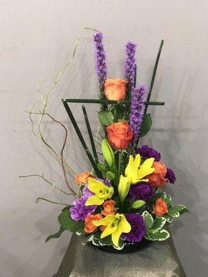 Tropical Nuevo with yellow lily, ranunculus and liatris