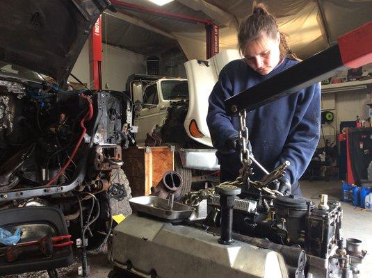 Edna is prepping engine to go back in after oil pan was changed.