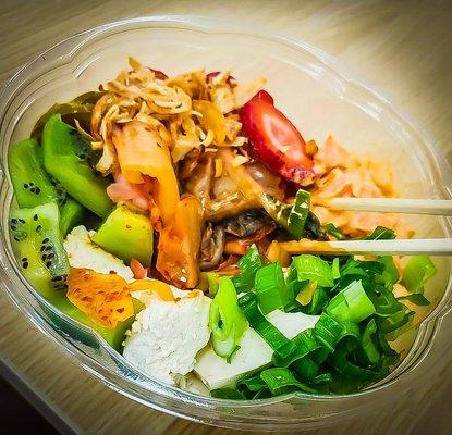 Poke Bowl with white rice, lettuce, kimchi, strawberry, avocado, tofu, green onions, crunch batter