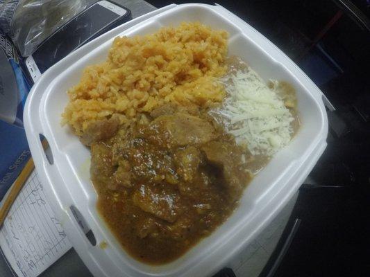 chili verde with a side of beans  and rice.